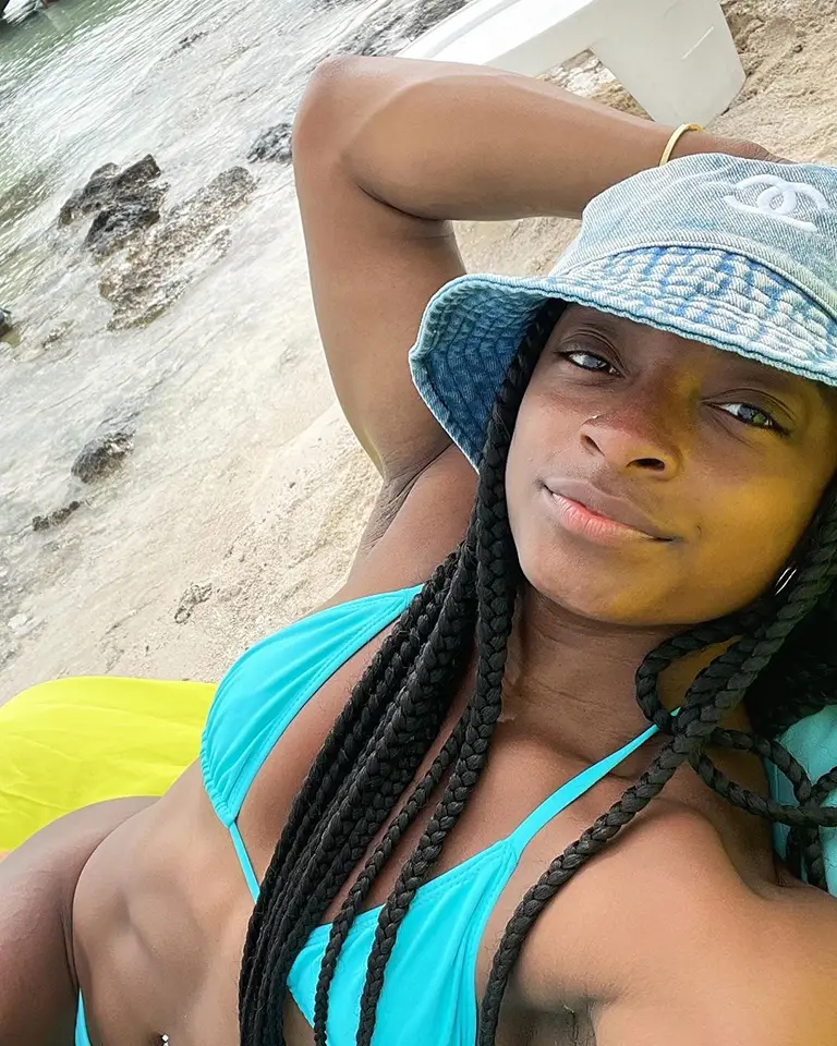 Wearing a blue bikini on the beach.